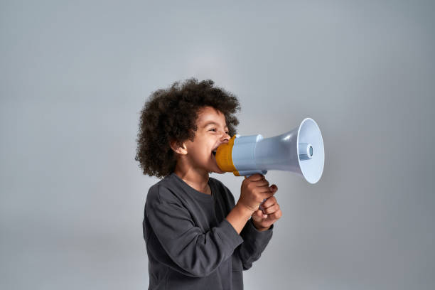 istock Little african american kid talking into megaphone 1309772755