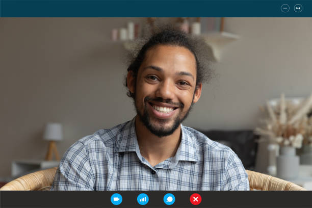 istock Smiling young african american man holding video call distant conversation. 1309773535