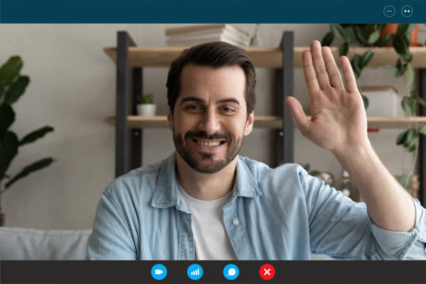 istock Smiling young handsome man looking at web camera, greeting friends. 1309773538
