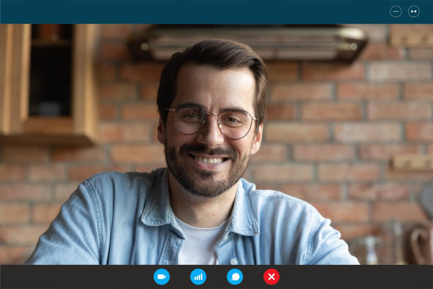istock Smiling young man in eyeglasses holding video call meeting. 1309773561