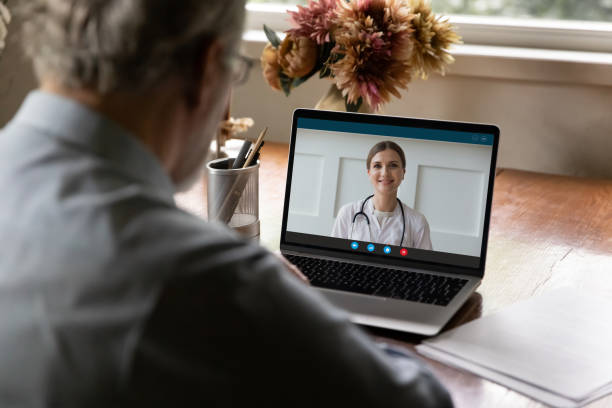 istock Retired old man holding video call consultation with doctor. 1309773564