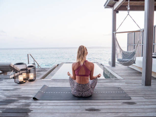 istock Woman exercising yoga inside luxury private villa 1309773573
