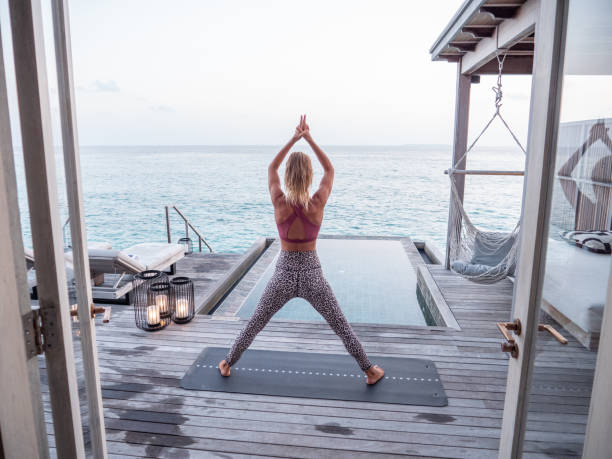 istock Woman exercising yoga inside luxury private villa 1309773779