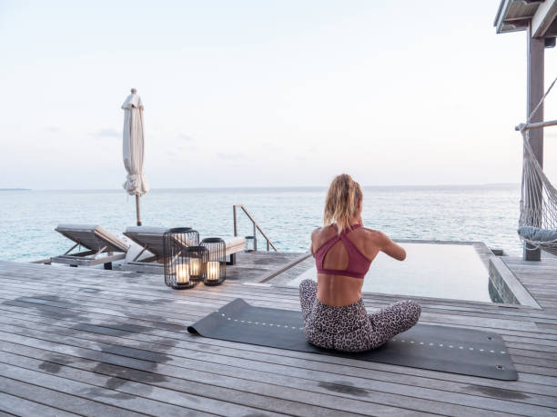 istock Woman exercising yoga inside luxury private villa 1309773851