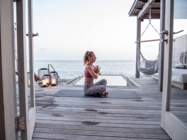 istock Woman exercising yoga inside luxury private villa 1309774039