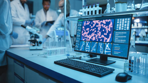 istock Shot of a Desktop Computer with Display Showing Gene Editing Interface. Diverse Team of Medical Research Scientists Have Meeting and Conduct Experiments in Medical Research Laboratory in Background. 1309776418