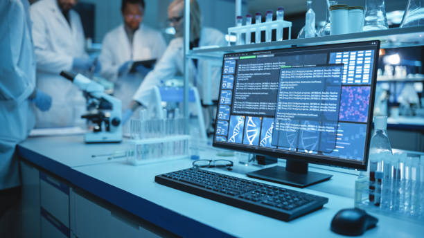 istock Shot of a Desktop Computer with Display Showing Gene Editing Interface. Diverse Team of Medical Research Scientists Have Meeting and Conduct Experiments in Medical Research Laboratory in Background. 1309776443