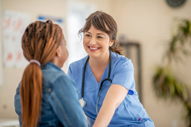 istock Smiling Caucasian Nurse With A Child Patient 1309776534