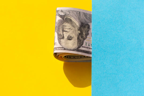 istock dollar bills on a yellow - blue background. Business concept. 1309777449
