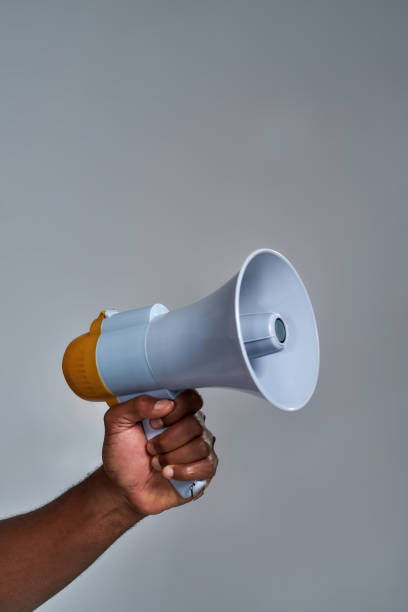 istock Loudspeaker held by african american person 1309777494