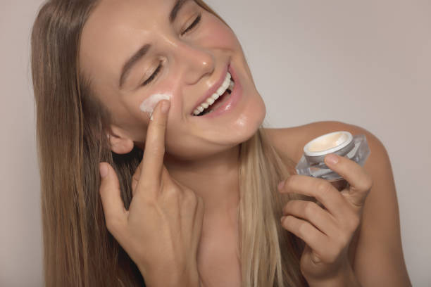 istock Smiling Model Applying Facial Cream 1309777646
