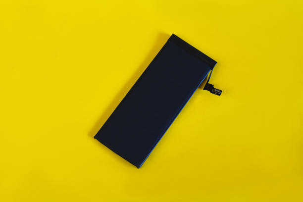 istock Swollen lithium ion polymer battery inside a mobile phone on  background. 1309777668
