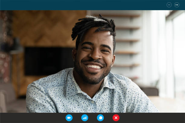 istock Smiling young african american handsome hipster guy holding video call. 1309784511