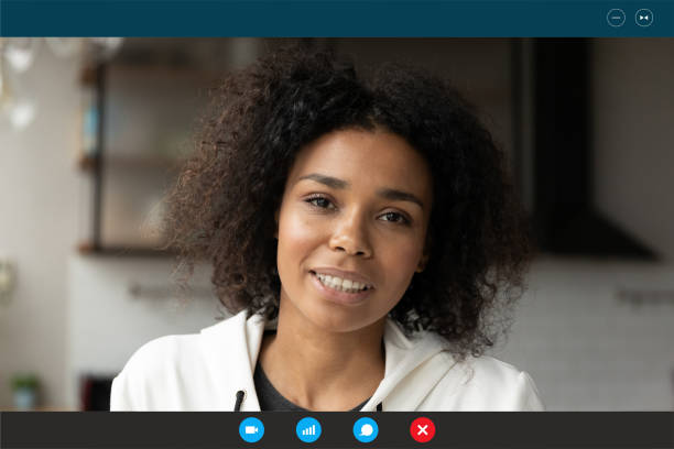 istock Smiling young african woman looking at web camera. 1309784515
