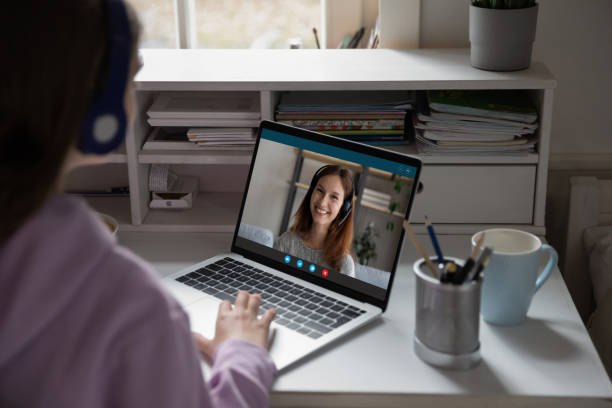 istock Schoolgirl enjoying online training webinar with teacher at quarantine. 1309784535