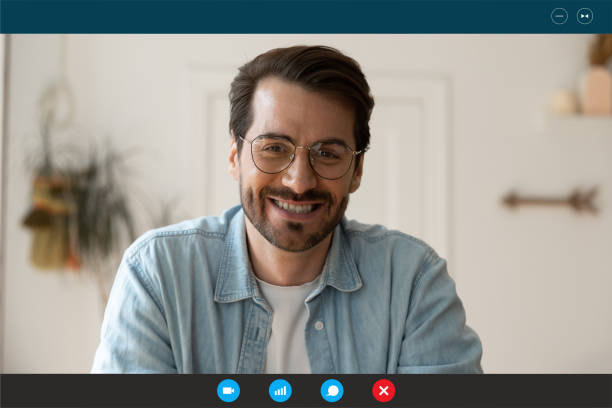 istock Handsome young 30s man in eyeglasses holding video call. 1309784536