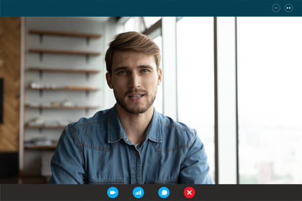 istock Focused young european appearance man passing online job interview. 1309784555