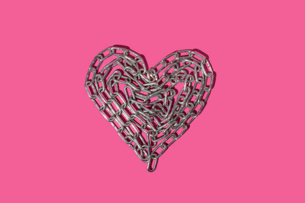 Heart made of chain on pink background. Strong love. stock photo