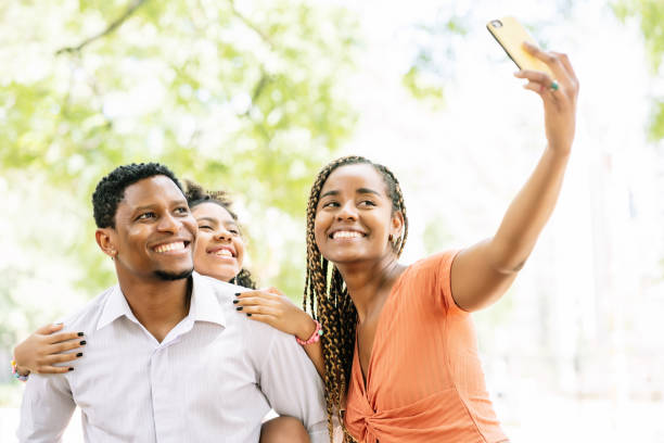 istock Family taking a selfie with a mobile phone at the park. 1309784911