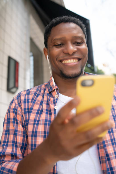 istock Man using his mobile phone on the street. 1309784935