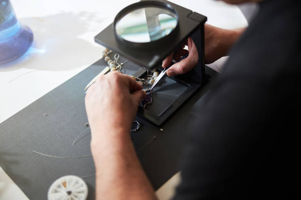 istock Jeweler working with a magnifier and jewelry tools 1309785251