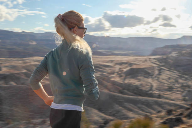 istock Female trail runner traverses mountain ridge in the morning 1309786529