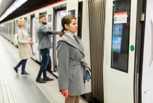istock Young woman waiting for subway train 1309789141