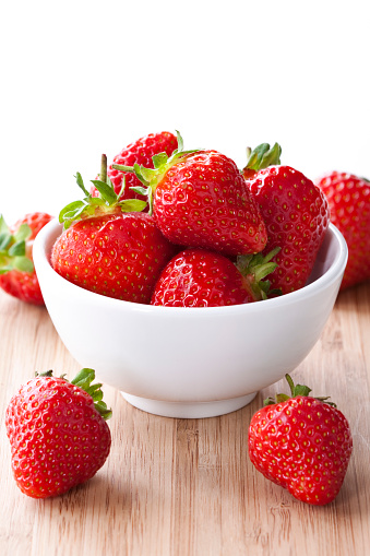 close up of some fresh strawberries, on a white background