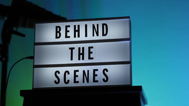 Behind the scenes letterboard text on Lightbox or Cinema Light box. Multi color LED on background. Sillhouette flash snoot hood on tripod. video production studio. Behind the scene Lightbox Behind the scenes letterboard text on Lightbox or Cinema Light box. Multi color LED on background. Sillhouette flash snoot hood on tripod. video production studio. Behind the scene Lightbox behind the scenes stock pictures, royalty-free photos & images