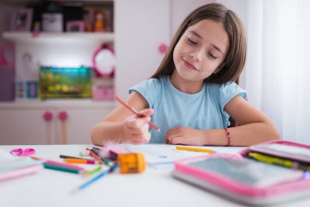 istock Cheerful girl finish her homework 1309789868