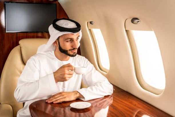 istock Arabian man wearing kandora flying on private jet 1309790056