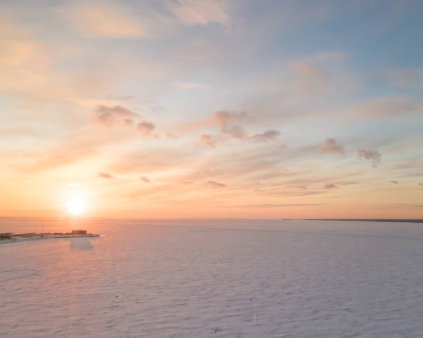 istock Ice on the frozen sea and bright colored sky at sunset 1309790375
