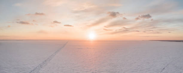 istock Ice on the frozen sea and bright colored sky at sunset 1309790896