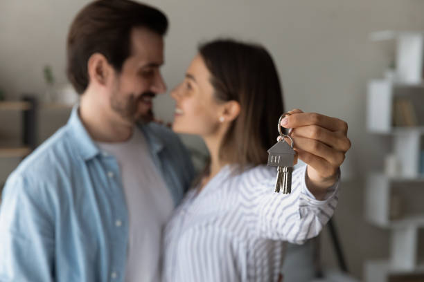 istock Close up couple excited by relocation, showing keys, first apartment 1309790992