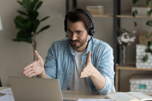 istock Close up confident man wearing headphones using laptop, internet meeting 1309791111