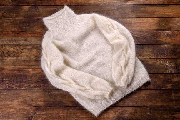 Knitted sweat made of woolen threads on a dark background. Manual work, hobby