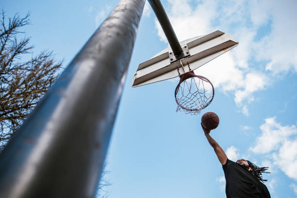 istock Basketball Player Practices on Outdoor Court 1309791615