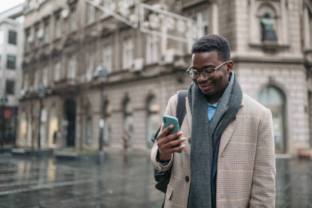 istock Handsome young African American businessman using a smart phone 1309792467