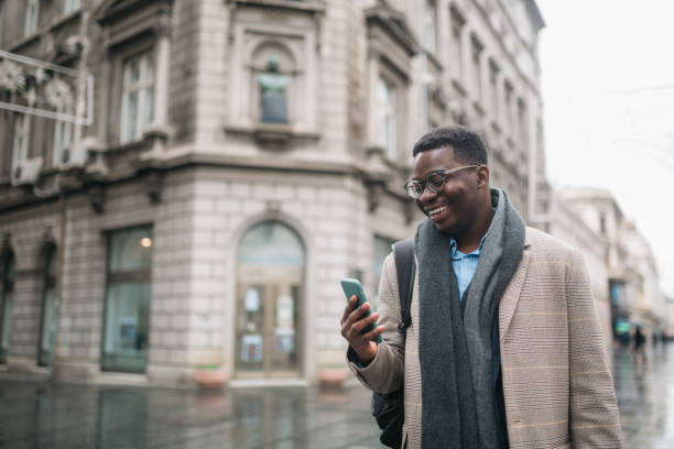istock Handsome young African American businessman using a smart phone 1309792496