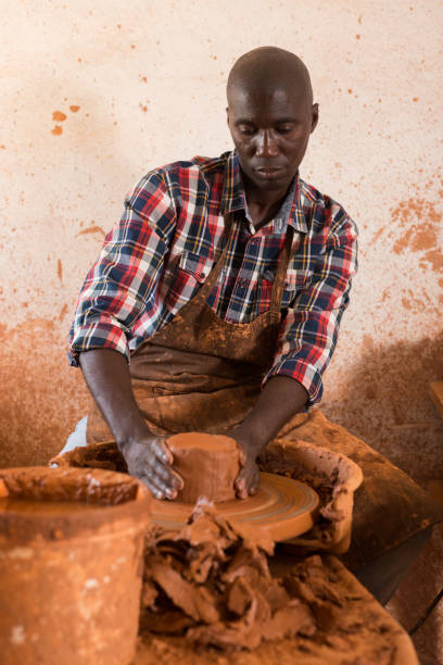 istock Craftsman woring with clay on potter wheel 1309792843