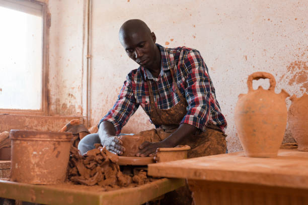 istock Man making ceramics on pottery wheel 1309792852