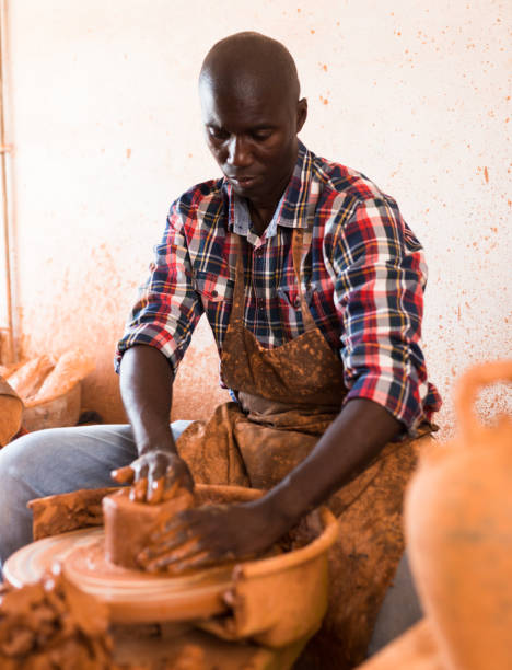 istock Man making ceramics on pottery wheel 1309792855