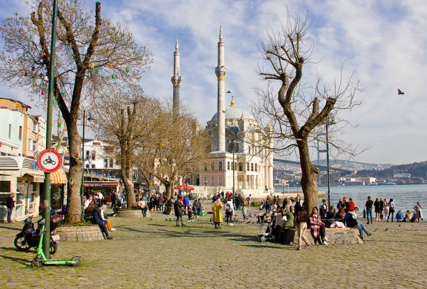 Istanbul, Turkey - March 14, 2021: Ortakoy besiktas view, which is one of the most touristic areas of Istanbul. The district is full of restaurants and cafes and has a unique view of the Bosphorus Bridge. There are also Ortaköy mecidiye Mosque and Bosphorus bridge and with pigeons, beşiktaş Istanbul.