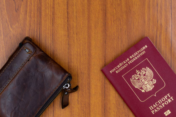 istock Russian passport and leather wallet  on a wood background 1309793542