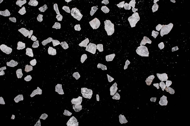 istock Large and small crystals of rock salt on a black background. 1309796032