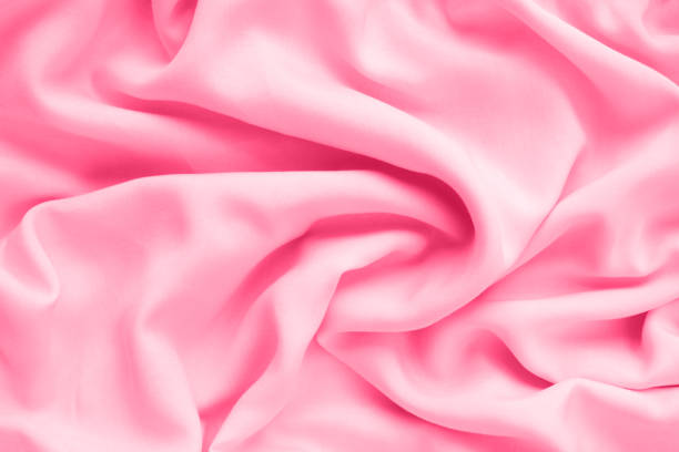 istock Silk texture, abstract background luxury light pink fabric with wavy folds 1309797093