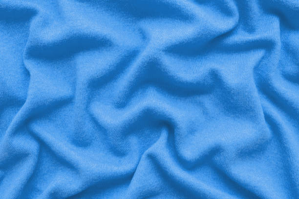 istock Silk texture, abstract background luxury blue fabric with wavy folds 1309797219