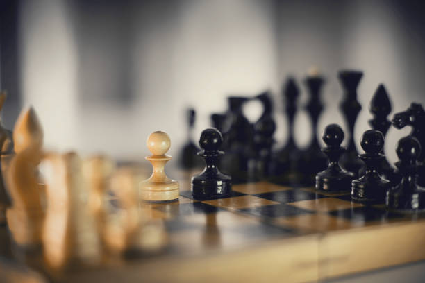 istock Two chess pieces are pawns: black and white. 1309797417