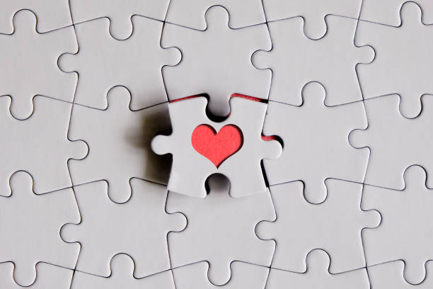 istock Red heart shape in the middle of a blank jigsaw puzzle 1309797496