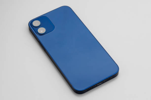 istock Blue modern smartphone with double-lens camera on gray background 1309797821